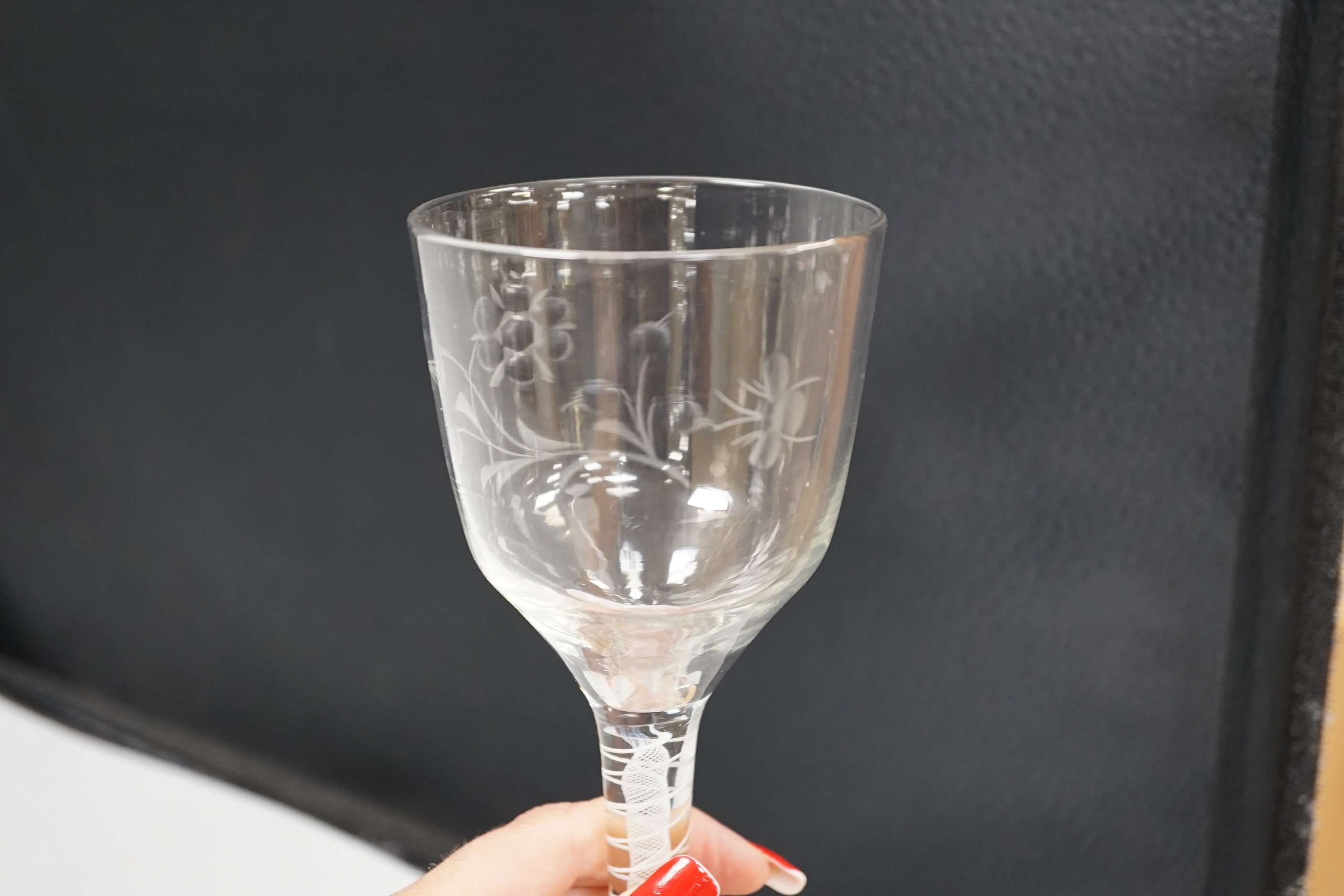 An English lead crystal DSOT goblet, c.1760, ogee bowl with tool marks and engraved with polished flora opposite a single insect which appears to be a bee, two spiral tapes around a gauze, conical foot, broken pontil, 18